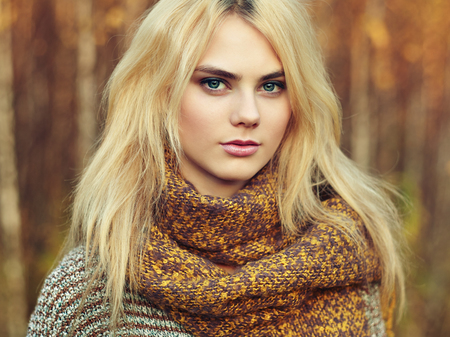Portrait of young beautiful woman in autumn pullover. Fashion photo. Blonde girl. Perfect make-upの写真素材