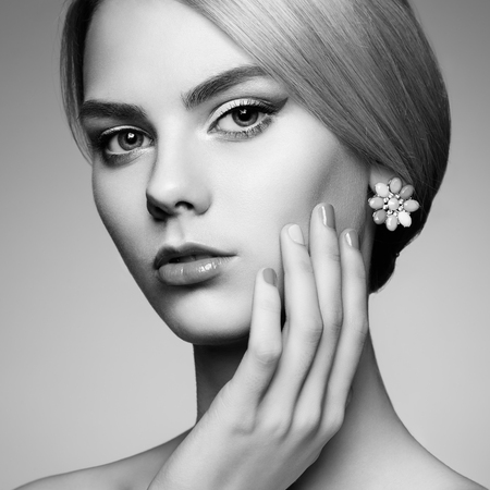Portrait of beautiful sensual woman with elegant hairstyle.  Perfect makeup. Blonde girl. Fashion photo. Jewelry. Black and whiteの写真素材