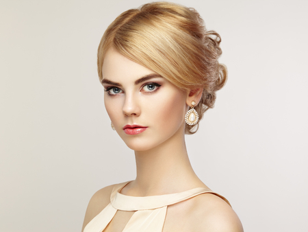Portrait of beautiful sensual woman with elegant hairstyle.  Perfect makeup. Blonde girl. Fashion photo. Jewelry and dressの写真素材