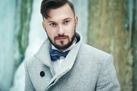 Outdoor portrait of handsome man in gray coat. Fashion photo. Beauty winter styleの写真素材