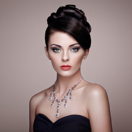 Fashion portrait of young beautiful woman with jewelry. Brunette girl. Perfect make-up.  Beauty style woman with diamond accessoriesの写真素材