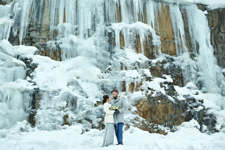 Happy couple hugging on rock on the background of nature. Fashion style. Family outdoors. Man and woman. Bride and groomの写真素材