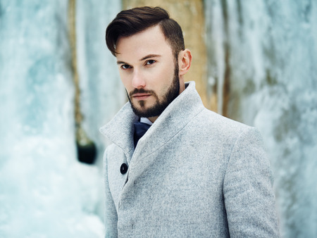 Outdoor portrait of handsome man in gray coat. Fashion photo. Beauty winter styleの写真素材