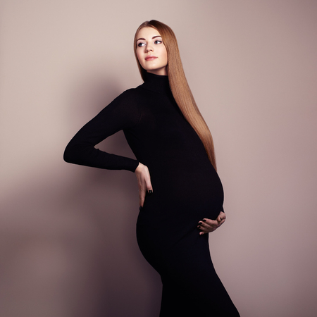 Portrait of the young pregnant woman. Pregnancy, love, people and expectation concept. Happy pregnant lady with long hairの写真素材