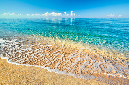 Sea view from tropical beach with sunny sky. Summer paradise beach. Tropical shore. Tropical sea. Exotic summer beach with clouds on horizon. Ocean beach relax, outdoor travelの写真素材