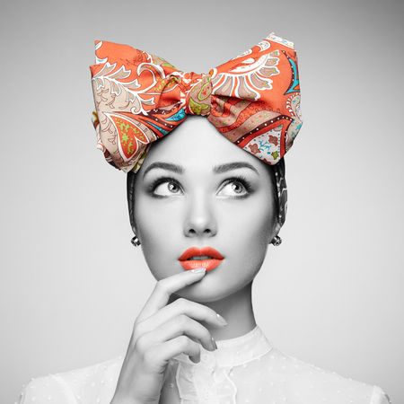Portrait of beautiful young woman with bow. Brunette girl. Beauty fashion. Cosmetic make-upの写真素材