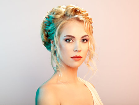 Blonde Girl with Long and shiny Curly Hair. Beautiful Model Woman with Curly Hairstyle. Care and...
