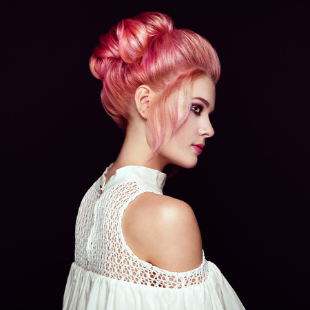 Blonde girl with elegant and shiny hairstyle. Beautiful Model Woman with Curly Dyed Hairstyle. Care and Beauty Hair products. Care and Beauty of Hairの写真素材