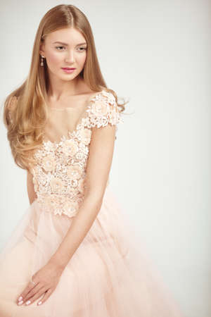 Beautiful Woman in Lace Wedding Dress. Beautiful Lady with Healthy and Beauty Hairの写真素材