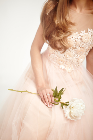 Beautiful Woman in Lace Wedding Dress.  Woman with a peony. Wedding Decorationの写真素材
