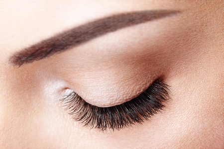 Female Eye with Extreme Long False Eyelashes. Eyelash Extensions. Makeup, Cosmetics, Beauty. Close up, Macro