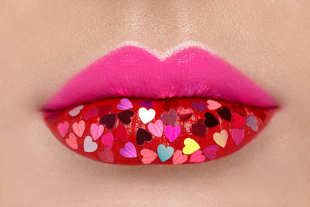 Beautiful Plump Pink Lips with pasted Hearts. Beauty Sexy Lips with Red Lipstick. Valentine's Day. Beautiful Love Make-upの写真素材