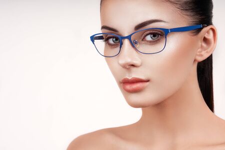 Woman with long eyelashes in eyeglasses. Vision correction. Poor eyesight. Spectacle frame. Makeup, cosmetics, beauty. Close up, macro