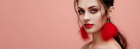 Brunette girl with perfect makeup. Pink backgroundの写真素材