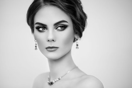 Portrait Beautiful Woman with Jewelry. Fashion Makeup and Cosmetics. Elegant Hairstyle. Beauty and Accessories. Black and white photoの写真素材