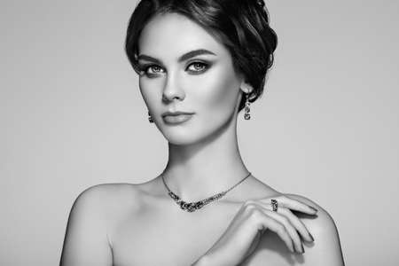 Portrait beautiful woman with jewelry. Model girl with manicure on nails. Beauty and Accessories. Black and white photoの写真素材