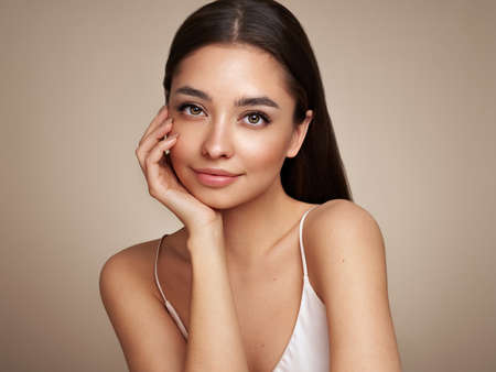 Portrait beautiful young woman with clean fresh skin. Model with healthy skin, close up portrait. Cosmetology, beauty and spaの写真素材