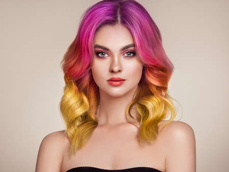 Beauty Fashion Model Woman with Colorful Dyed Hair. Girl with Perfect Makeup and Hairstyle. Model with Perfect Healthy Dyed Hair. Care and Beauty Hair Productsの写真素材