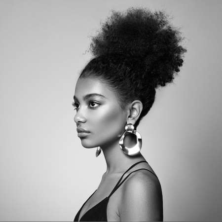 Beautiful smiling girl with curly hairstyle stock photo Women, African Ethnicity, Fashion Model, One Woman Only. Black and white photoの写真素材