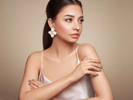 Portrait beautiful young woman with clean fresh skin. Model with healthy skin, close up portrait. Cosmetology, beauty and spaの写真素材