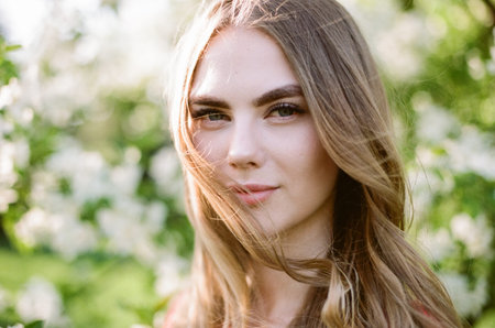 Beautiful young woman in summer garden. Beauty summertime. Film photography