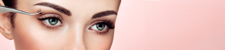 Beautiful Woman with Extreme Long False Eyelashes. Eyelash Extensions. Makeup, Cosmetics. Beauty, Skincare. Woman Glues Eyelashesの写真素材