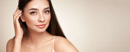 Portrait beautiful young woman with clean fresh skin. Model with healthy skin, close up portrait. Cosmetology, beauty and spaの写真素材
