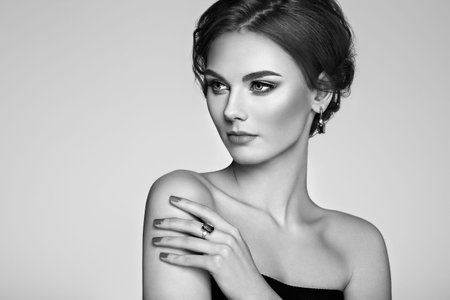 Portrait beautiful woman with jewelry. Model girl with manicure on nails. Beauty and Accessories. Black and white photoの写真素材