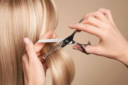 Hairdresser cuts long brunette hair with scissors. Hair salon, hairstylist. Care and beauty hair products. Dyed hairの写真素材