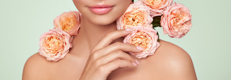 Portrait beautiful young woman with clean fresh skin. Model with healthy skin, close up portrait. Cosmetology, beauty and spa. Girl with a rose flowerの写真素材