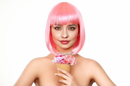 Beauty model portrait with pink hair. Bob short Haircut. Beautiful glamorous girl with flower ice creamの写真素材
