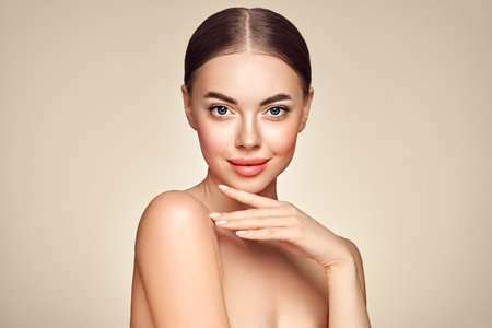 Portrait beautiful young woman with clean fresh skin. Model with healthy skin, close up portrait. Cosmetology, beauty and spaの写真素材