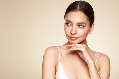 Portrait beautiful young woman with clean fresh skin. Model with healthy skin, close up portrait. Cosmetology, beauty and spaの写真素材
