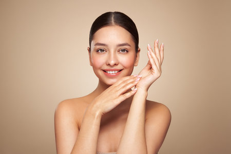 Portrait beautiful young woman with clean fresh skin. Model with healthy skin looks at an empty space, close up portrait. Cosmetology, beauty and spaの写真素材