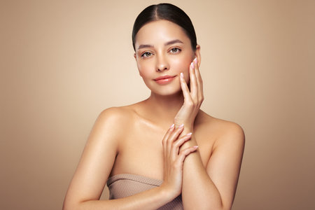 Portrait beautiful young woman with clean fresh skin. Model with healthy skin looks at an empty space, close up portrait. Cosmetology, beauty and spaの写真素材