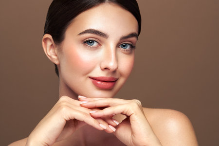Portrait beautiful young woman with clean fresh skin. Model with healthy skin looks at an empty space, close up portrait. Cosmetology, beauty and spaの写真素材