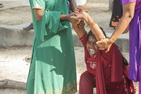 PANGKOR ISLAND, MALAYSIA - February 17, 2011 Masi Magam festival  women go into trance before being pierced the tongueのeditorial素材