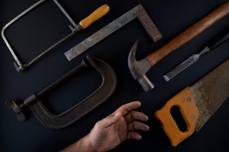 Old and used tools on black background. Old and used tools on black background.