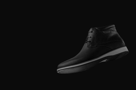 Photo of black shoe with black background