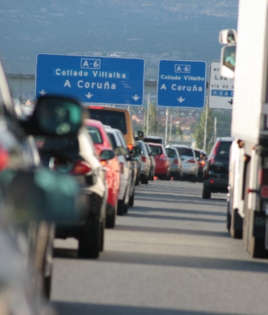 Madrid, Castilla y Leon, Spain  July 23, 2010  Traffic jam during rush hour on a Spanish highway, the signboard indicates the direction for La Coruna のeditorial素材