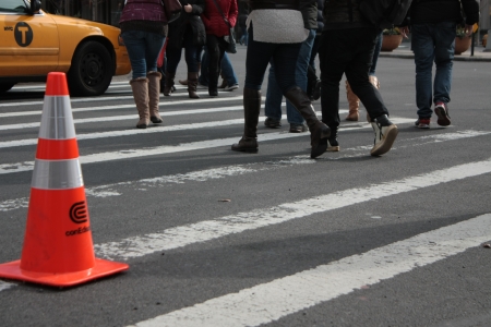 Zebra Crossing  New York City, NY, USA  January 20, 2013  Pedestrians crossing a zebra crossing in the Lincoln Centre area  A Yellow taxi in engaging the passage and people are obliged to detourのeditorial素材
