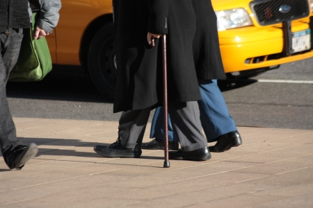 New York City, NY, USA  January 20, 2013  Senior Citizen walking with the aid of a cane beside a carer, Lincoln Square  のeditorial素材