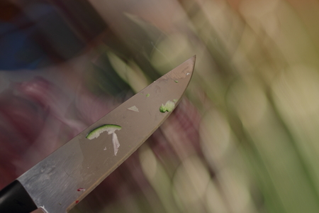 Long Exposure of a long kitchen knife cutting vegetablesの写真素材
