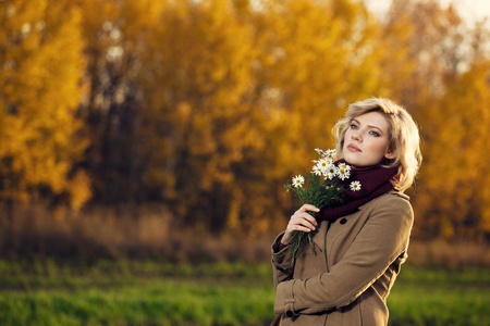 Woman with camomile bouquetの写真素材
