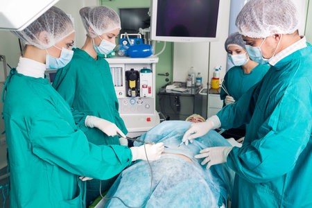 Surgery team operating in a surgical room
