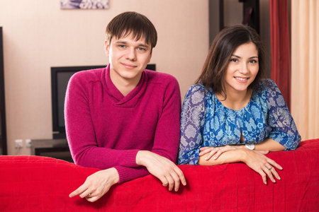Couple leaning over their couchの写真素材