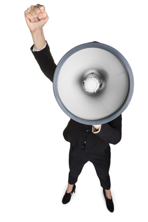Business woman with megaphone yelling and screaming isolated on white backgroundの写真素材