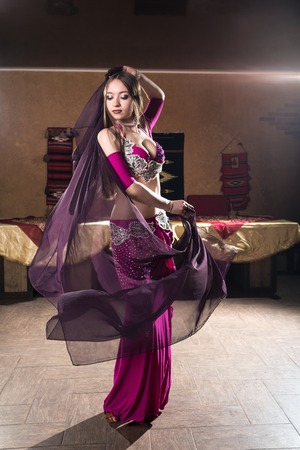 A portrait of a beautiful belly dancer in arabic cafeの写真素材
