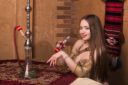 Arabian lady smoking hookah in the coffee shop