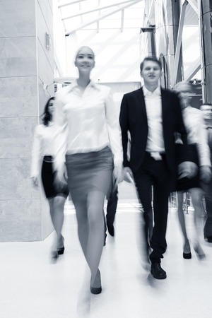 Businesspeople moving along the corridorの写真素材